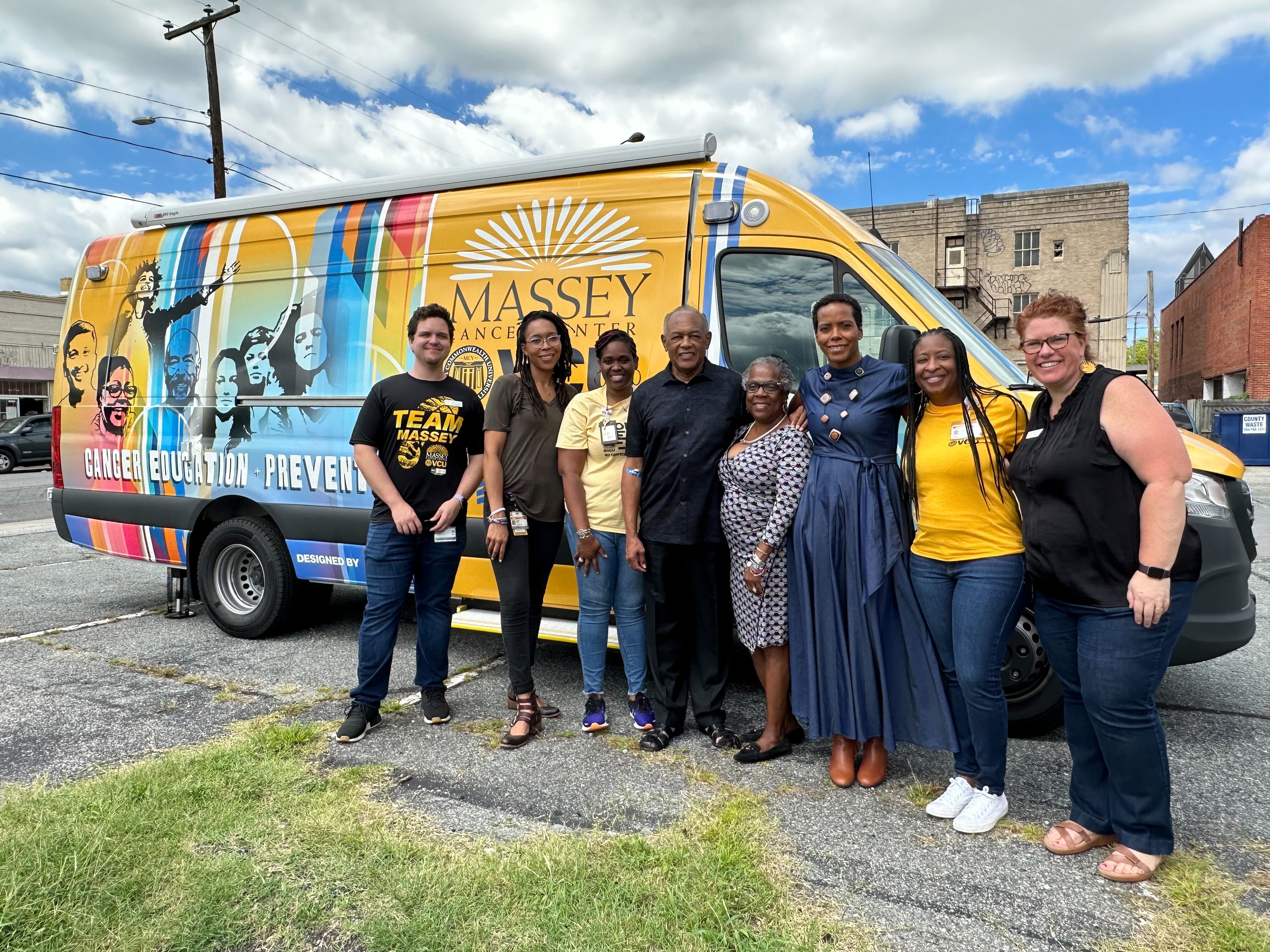 Clinical Trial Event Organizers pose in front of Massey on the Move Van