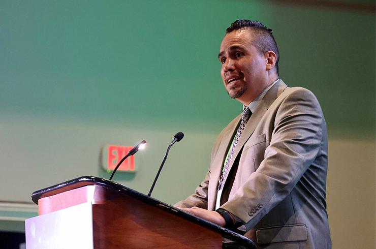 Trevino pictured at podium at AACR annual meeting